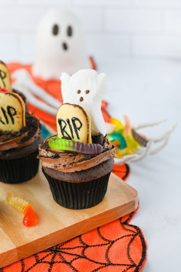 A display of Graveyard Cupcakes on a wooden board.