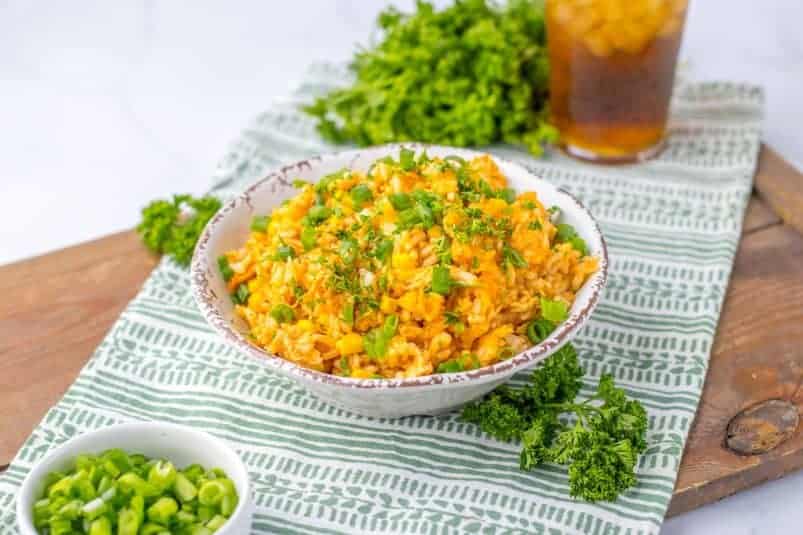 A whole chicken seasoned with herbs and spices in a slow cooker, ready to be cooked.