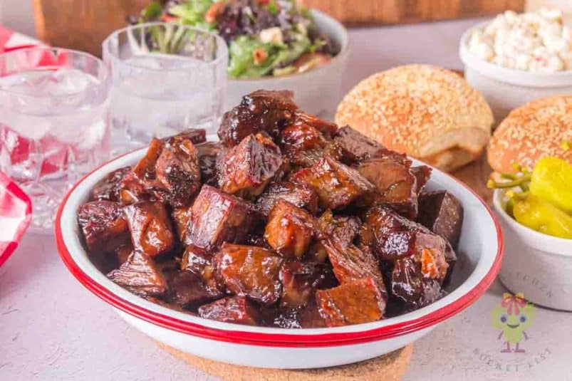 Serving bowl with chuck roast burnt ends covered with the burnt ends sauce.