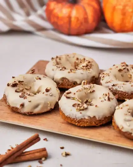 Pumpkin spice donuts sprinkled with pecans.