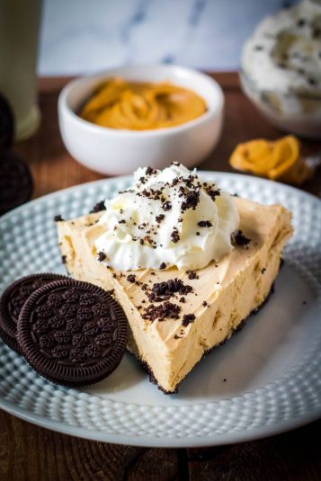 Closeup of crispy beef in a bowl with green onions and sesame seeds.