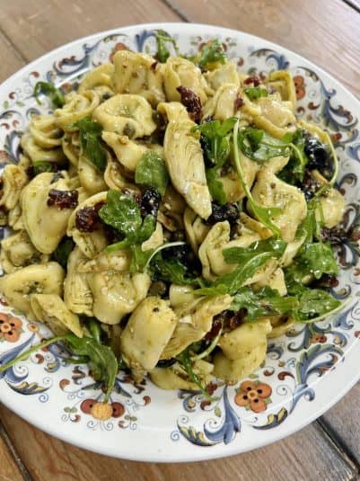 Finished pesto tortellini salad in decorative bowl.