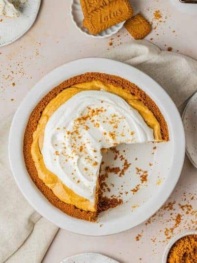 Biscoff Pumpkin Pie in a pie dish with slices taken out.