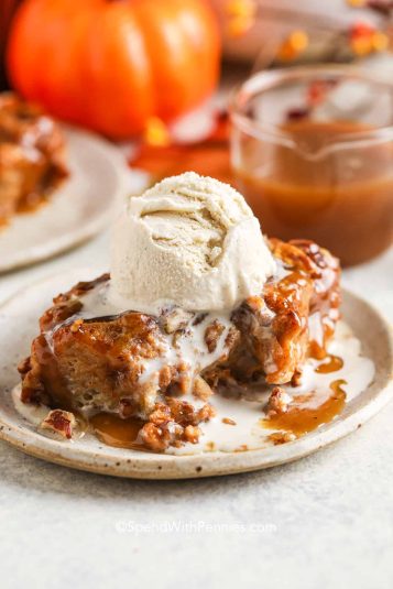 Piece of Pumpkin Bread Pudding with a bite taken out and ice cream on top.