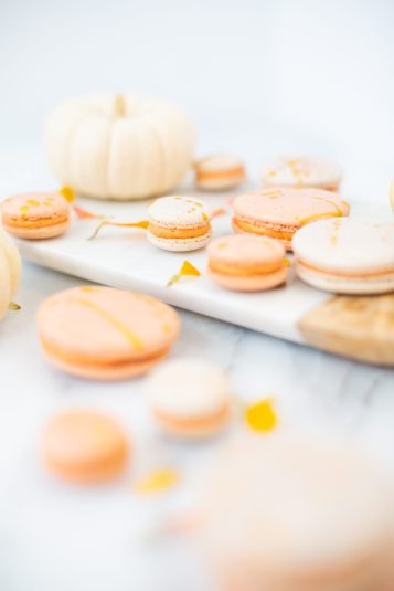 A display of Gold Splattered Pumpkin Spice Macarons.
