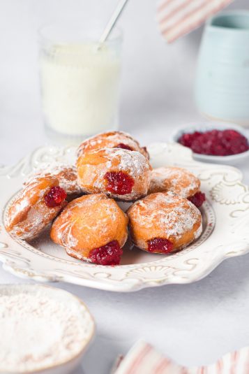 A white plate filled with the finished Air Fryer Jelly Donuts.