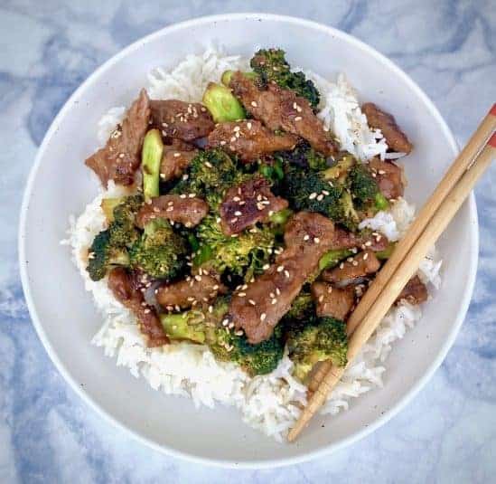 Beef Broccoli over rice in white bowl.