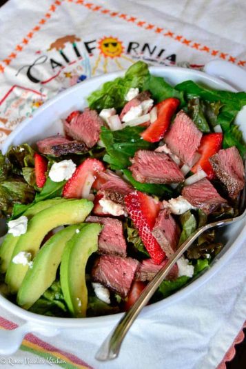 Roasted chicken and vegetables in a skillet on a cutting board.