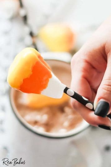 Thanksgiving cake pops sticking up in a jar of candy corn.