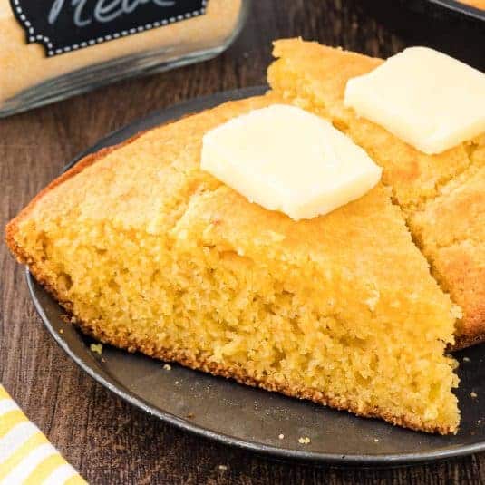 Up close picture of corn bread with butter.