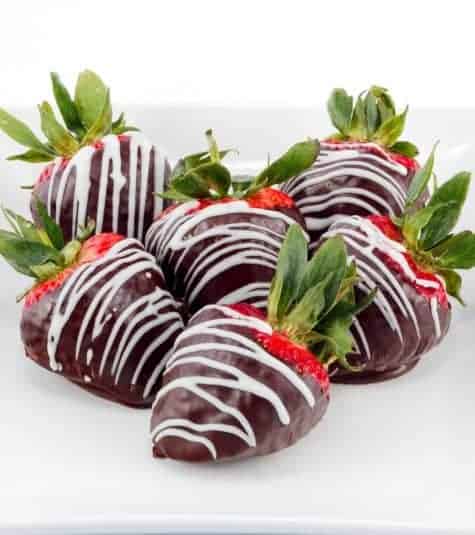Chocolate covered strawberries on a plate.