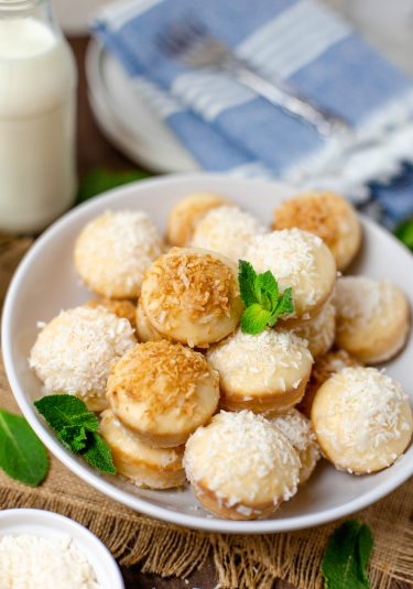 Plate of glazed coconut donut holes.