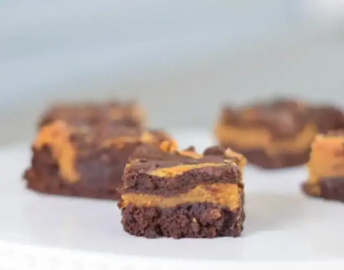 Image shows a closeup of a spoon holding some Cheesy Beef and Rice Casserole with the full skillet behind it.