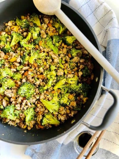 Skillet filled with stir fried ground pork and broccoli.