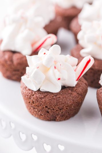 Cookies on a white cake plate.