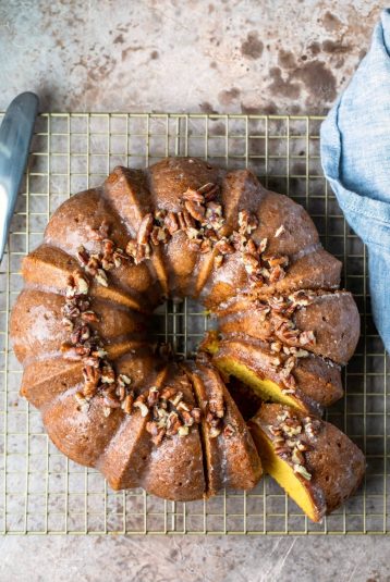 Irish cream bundt cake on a gold wire cooling rack.