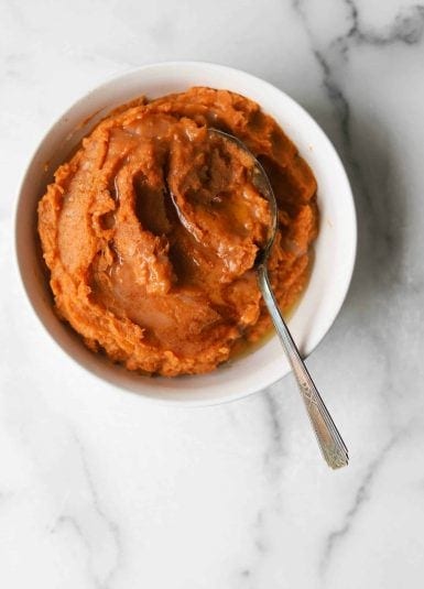 Maple mashed sweet potatoes in a white bowl.