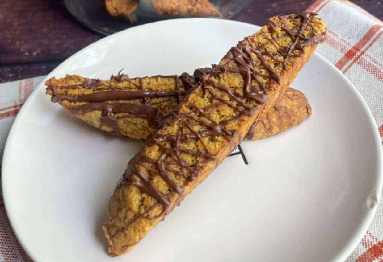 A slice of pumpkin banana bread on a white plate.