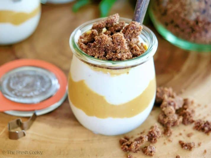 Pumpkin Spice Yogurt in jar layered into a parfait and topped with graham cracker crumble.