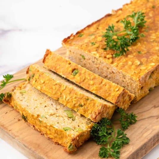 Homemade Turkey meatloaf for dogs on a wood cutting board.