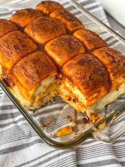 Pan with turkey reuben sliders and one taken out.