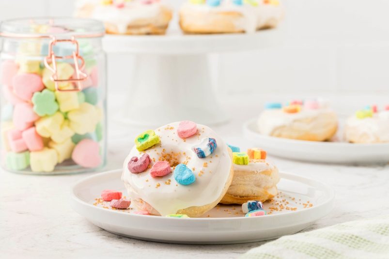 air fryer Lucky Charms marshmallow donuts for St. Patrick's Day or Easter made with canned buttermilk biscuits on a white plate.