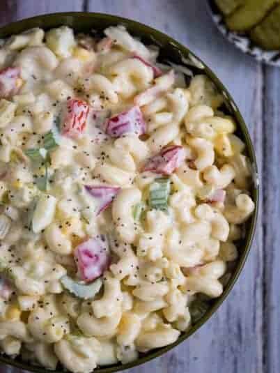Chocolate coca cola cake on a white plate topped with ice cream and a cherry.