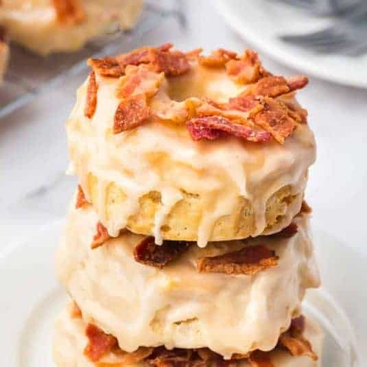 Air Fryer Maple Doughnuts With Bacon, a simple and delicious homemade donut recipe made with biscuit dough and topped with glaze.