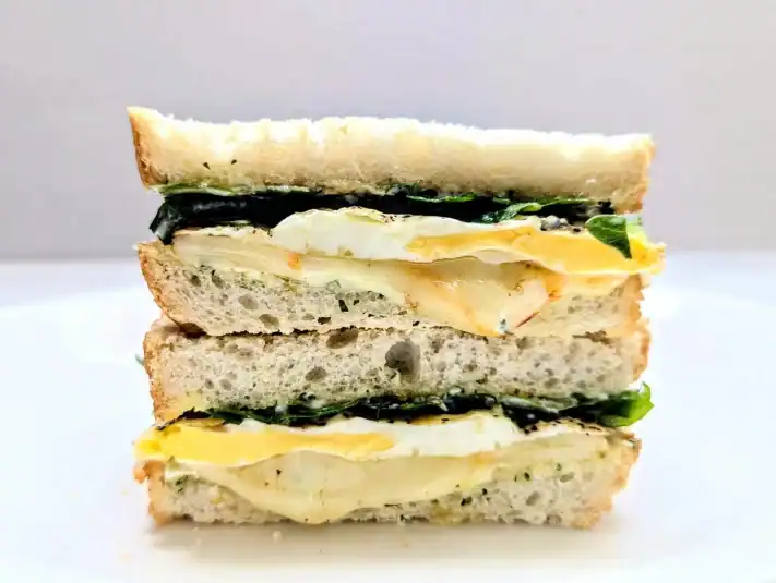 Fried Egg Sandwich with Herby Mayo cut in half and stacked on top of each other.
