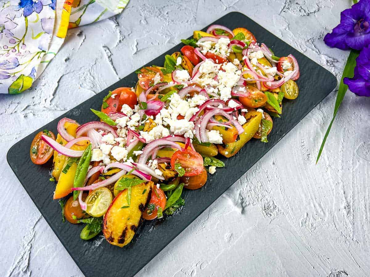Shrimp skewers on a white plate with lemon wedges.