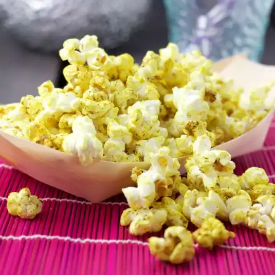 Bowl of golden curry-spiced popcorn.