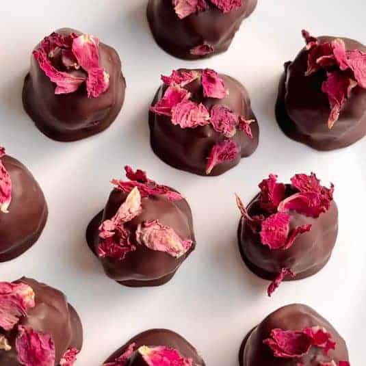 Chocolate rose truffles sprinkled with dried rose petals.