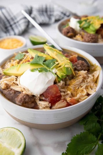 Crockpot slowcooker taco soup in white bowl.