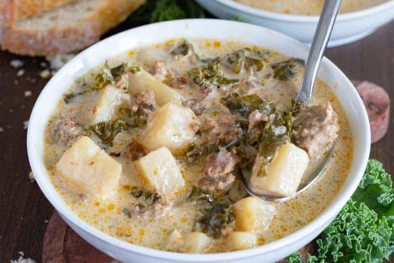 zuppa soup with potatoes and sausage in a bowl ready to serve.