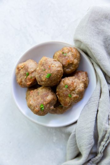 Air Fryer Turkey Meatballs in a white bowl with parsley.
