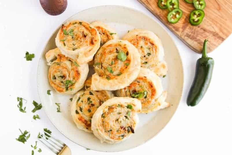 A plate with baked roll ups on them ready to serve for any occasion.