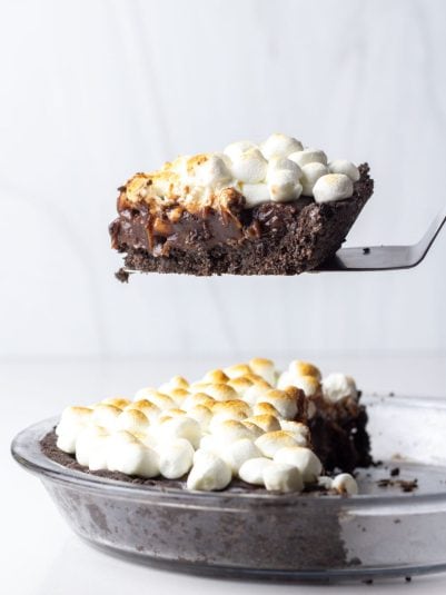 A slice of hot chocolate pie on a pie server above half a hot chocolate pie.