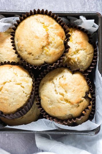 A container filled with baked pineapple muffins.
