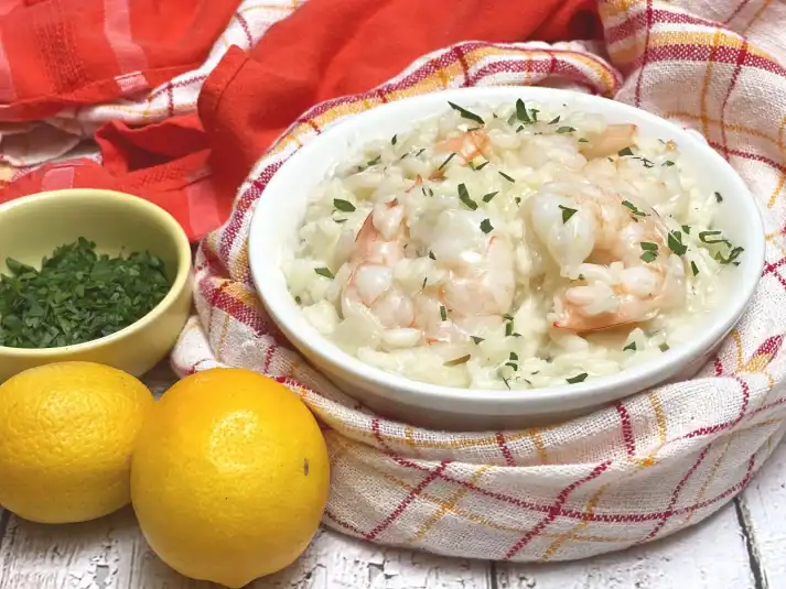 A finished Risotto with Prawns amid ingredients.