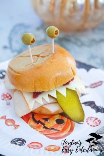 Olive eyes, a pickle tongue, and cheese teeth make this silly monster sandwich.
