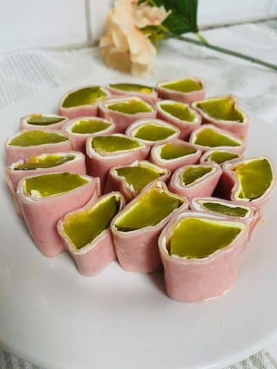 Melting moments cookies on white plate with snowman mug in background.