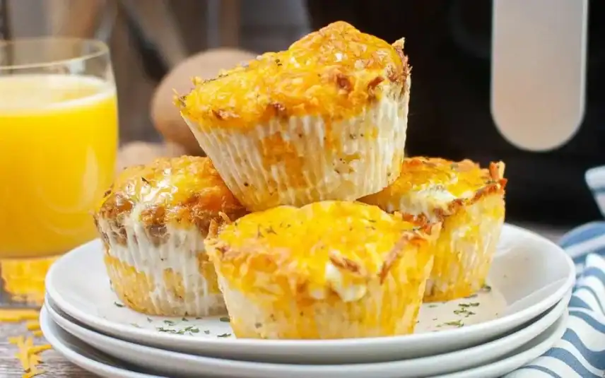Golden meatballs with a sprinkle of herbs on a white plate, with marinara sauce.
