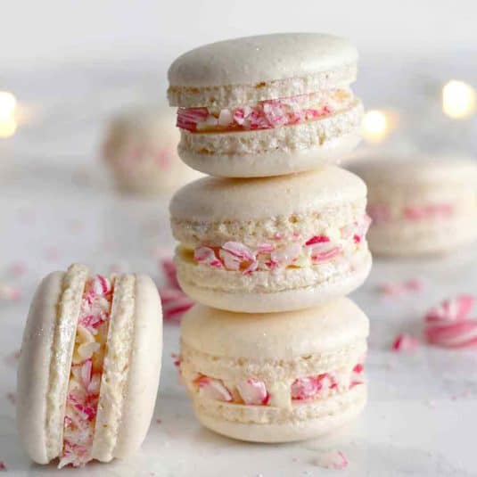 3 Vegan Christmas Macarons Stacked On Top Of One Another.