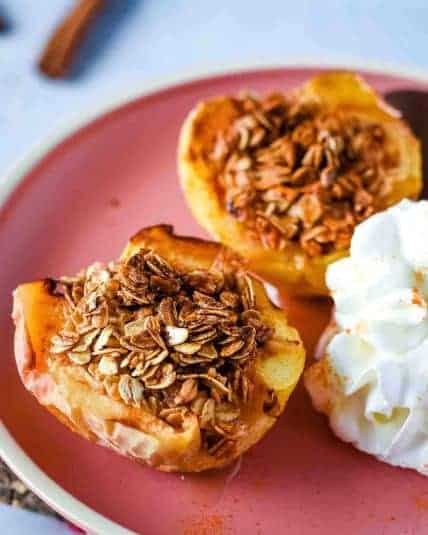 Air fryer bananas on a white plate over a rustic wooden cutting board with a pink linen.