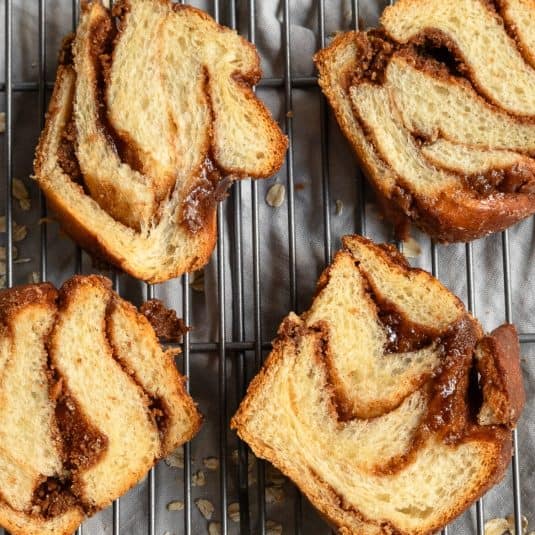 Overhead of 4 slices of cinnamon babka on cooling rack.