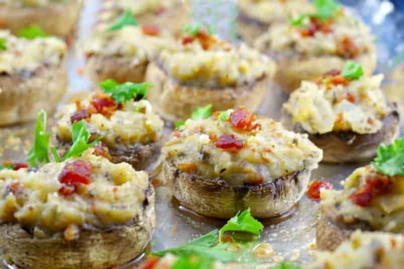 Pierogi stuffed mushrooms on aluminum foil lined baking sheet.