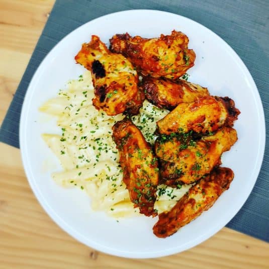 Spicy Mango Wings on a plate.