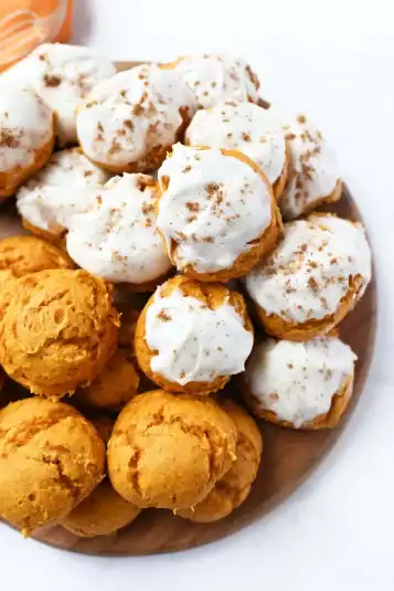 Fluffy iced Pumpkin spice cake mix cookies on a tray.