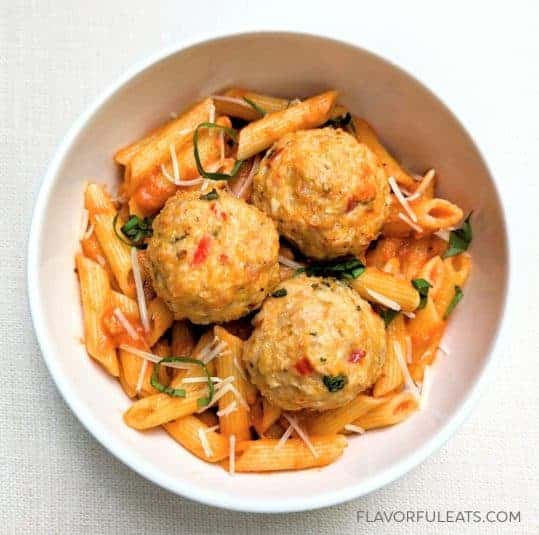 A white bowl filled with Calabrian Chicken Meatballs.