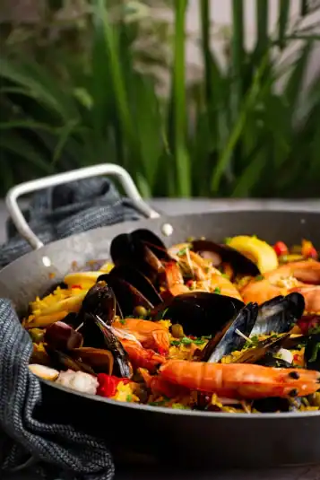A close-up shot of paella where the seafood is clearly visible.